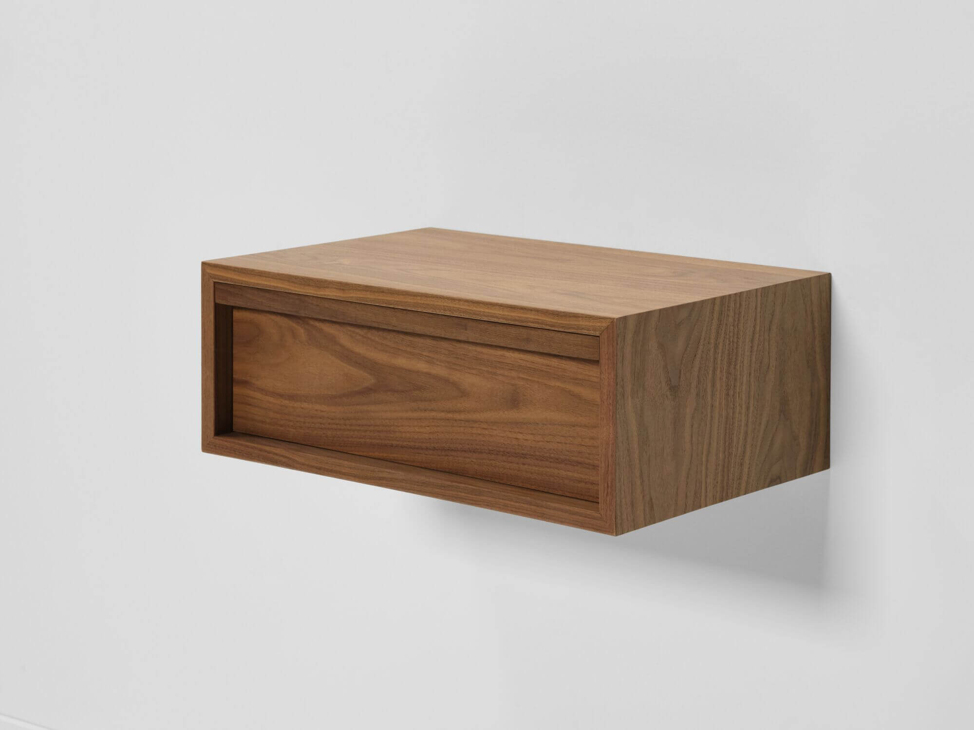 Detail view of modern walnut floating nightstand